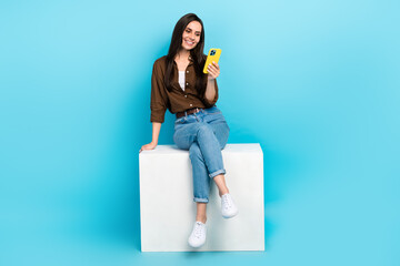 Full body photo of young influencer woman sit platform gadget texting her friends online...