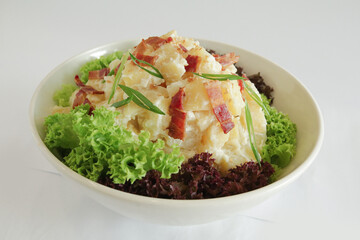 chef handmade potato salad with bacon and tartar salad sauce in lettuce bowl on white background appetiser Christmas festival party halal food hotel cuisine restaurant menu