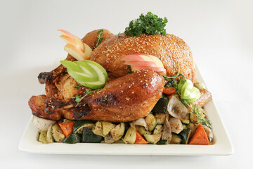 chef bbq roasted grill marinated whole big turkey chicken meat with mixed potato vegetables in plate on white background appetiser Christmas festival party halal food hotel cuisine restaurant menu