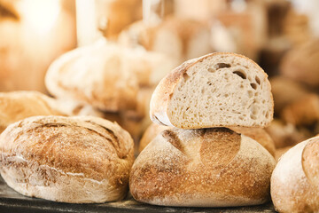 Fresh baked loaves of wheat bread on the market counter. Big beautiful bread. Sale of baked goods.