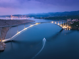 Naklejka premium Bridge over the sea at sunset. Aerial view of modern Krk bridge