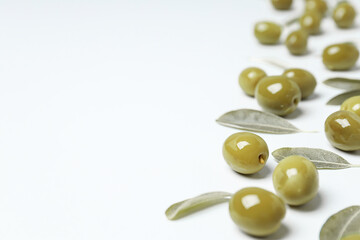 Olives and leaves on white background, space for text