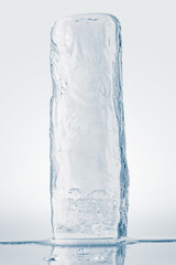 Transparent melting ice block, isolated on white background.