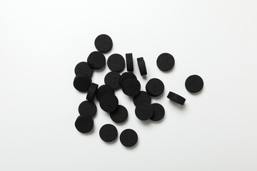 Tablets of activated carbon on a light background