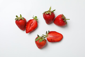 Pieces of strawberries on white background, top view