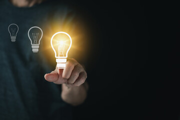 Creative idea business with light bulb concept, Man hand  touch light bulb, innovative idea of ​​inspiration from online technology. Business growth, creative thinking and learning.