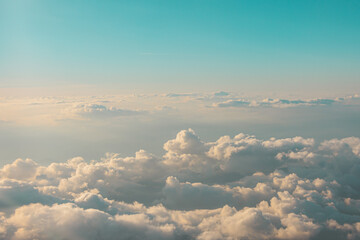 Aerial cloudscaspe view of the picturesque clouds and sky from a height in the morning at dawn over the horizon.
