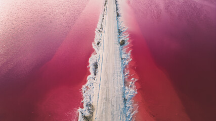 Aerial view of pink salt lake. Salt production plants evaporated brine pond in a salt lake. Salin de Giraud saltworks in the Camargue in Provence, South of France - obrazy, fototapety, plakaty