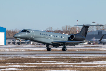 Fototapeta na wymiar Takeoff of a business jet at a winter airport
