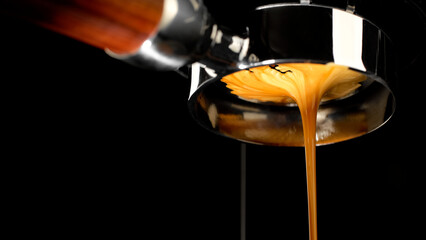 Pouring coffee espresso stream through Bottomless Portafilter. Creamy and perfectly pulled espresso