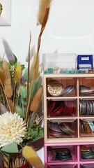 Plastic cabinet with a lot of stationery on the table.