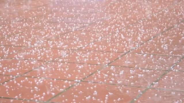 Large hail falling on the road, heavy rain, summer