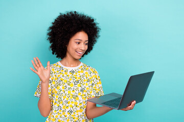 Photo of cute young schoolgirl waving palm say hello every member google conference laptop elearner isolated on aquamarine color background © deagreez