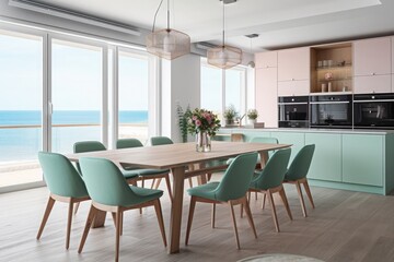Modern kitchen with a dining table, modern integrated kitchen appliances and a wide view from the picture window in a modern mint tone.