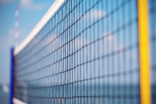 Volleyball net on the beach close-up against the blue sky