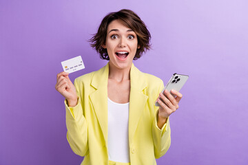 Photo of surprised funny girl brown hair wear lime yellow suit holding plastic mastercard phone...