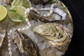 large, beautiful, fresh oysters on a dark table. Close up