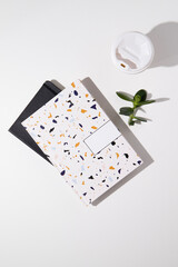 Flat lay home office desk. Workspace with notebooks, a cup of coffee and a plant on a white background. Flat lay, top view. Woman home office desk.