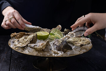 large, beautiful, fresh oysters on a dark table. Close up