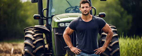 Foto op Canvas Young handsome farmer in front of tractor in farm field. wide banner © Michal
