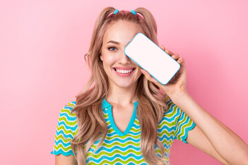 Photo of lovely positive girl wavy hairdo wear stylish blouse showing screen website empty space isolated on pink color background