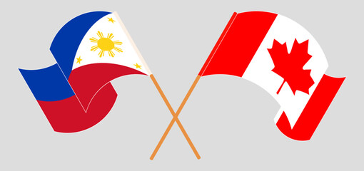 Crossed and waving flags of the Philippines and Canada