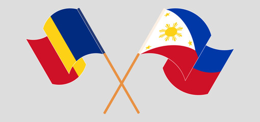 Crossed and waving flags of Romania and the Philippines