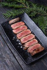 Delicious marbled meat on a dark background. Close up