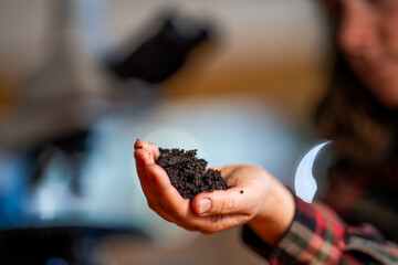 young Female soil scientist holding a soil in a hand in a soil laboratory in australia in a...