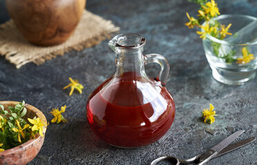 St. John's wort oil with fresh Hypericum perforatum flowers