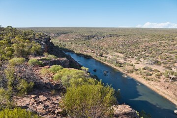 Fototapeta na wymiar Looking into a gorge and to a river from Hawk's Head Lookout in Kalbarri National Park, Western Australia. Stunning views of the Kalbarri Gorges and Murchison River. Western Australian landscapes.