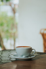 Cup of latte on wooden table in cafe shop