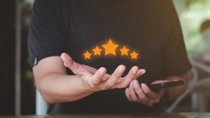 Reward and Satisfaction Concept. Businessman showing and giving five stars on hand. Business Quality Assessment, ISO, Quality Assurance, Certification.