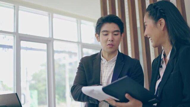 Asian businessman working, communicating business with colleagues in office