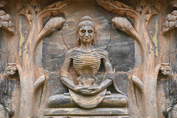 Stone statue of buddha at Mahabodhi Temple Complex in Bodh Gaya, India.Buddha sculpture tells the...