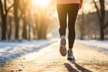 Foto op Plexiglas Legs of a female runner jogging in a park on a winter afternoon © Keitma