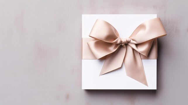Banner with a white box with a bow on an empty gray background with copy space. White gift box isolated on grey stone background. Flat lay photo of white present with pink ribbon.