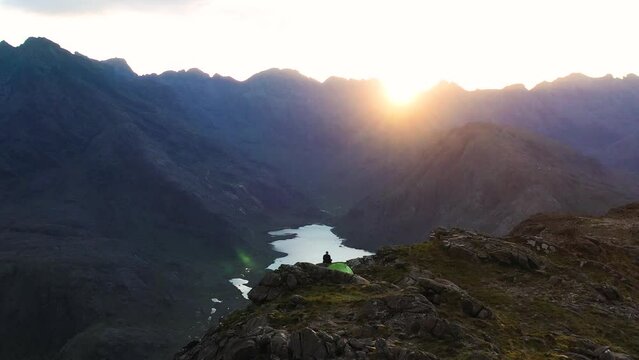 Aerial view of the Jagged Mountains, Lochs and Sea on the Isle of Skye, Scotland UK at Sunset with Colourful Skies. Hiking and camping in the Cuillin Mountains. 