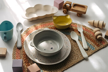 Cute children's plates and dishes shape of a bear. Creative serving for baby. Concept of kids menu, nutrition and feeding.