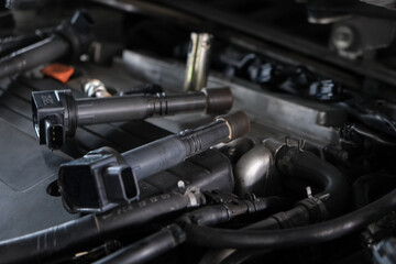 Mechanic man hand repair ignition on car engine