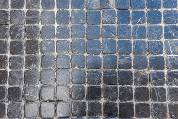 black stone tiles embedded on the streets of Genoa in Italy