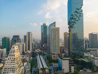 Fototapeta na wymiar Aerial view city office building with BTS urban train transport sunset sky Silom district