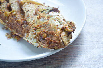 deep fried red snapper with turmeric powder on plate