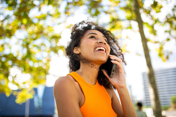 happy young woman talking with cellphone outdoor