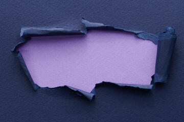 Frame of ripped paper with torn edges. Window for text with copy space blue lilac colors, shreds of notebook pages. Abstract background.