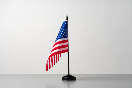 Little flag of USA on gray table close up