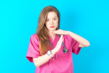 young beautiful doctor woman being upset showing a timeout gesture, needs stop, asks time for rest...