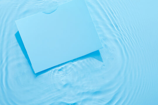Water blue surface abstract background. Waves and ripples texture of cosmetic aqua moisturizer with bubbles and blank space for text or product.