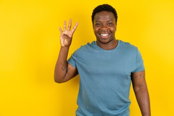 MODEL showing and pointing up with fingers number four while smiling confident and happy.