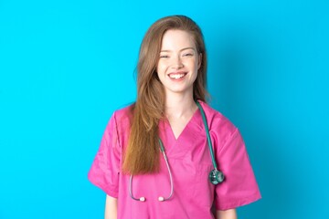 young beautiful red haired doctor woman with a happy and cool smile on face. Lucky person.